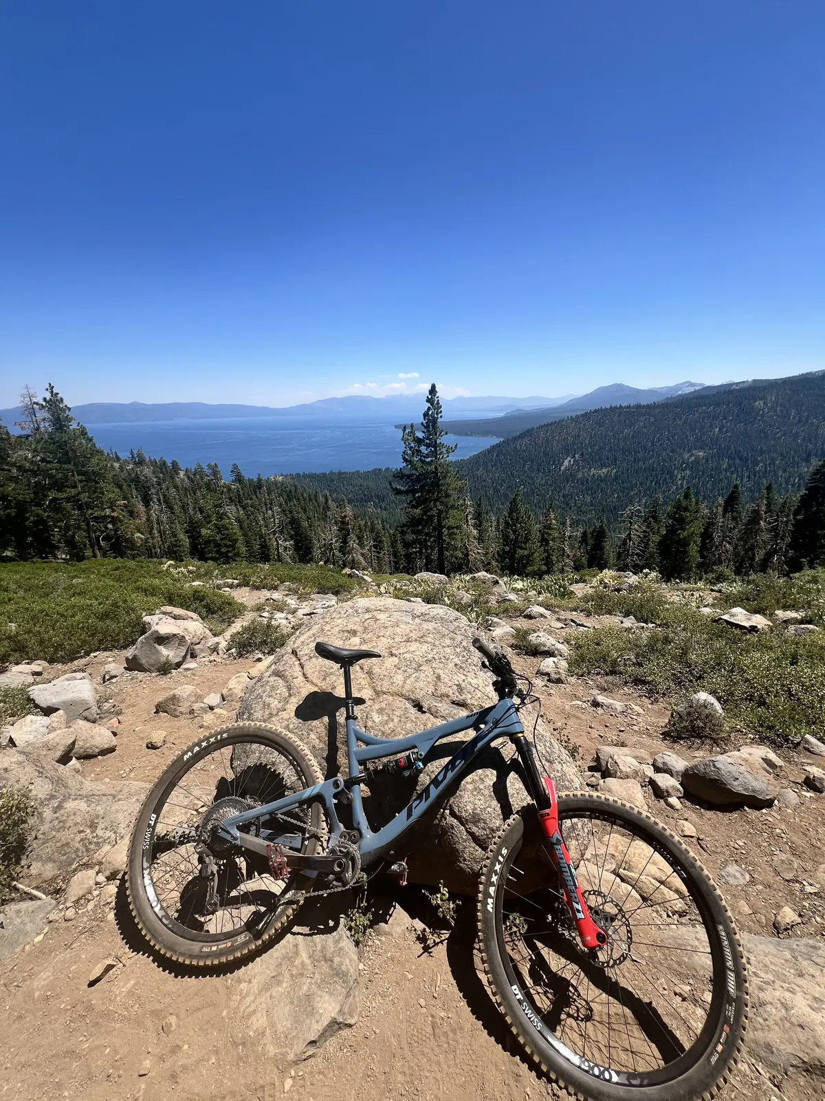 Mountain bike resting on rocks above a lake